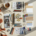 Homemade journal bundle with pens, pencils, markers, stickers, and stationery